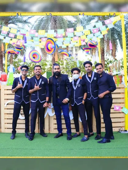 Suited up in all black for a carnival-themed event. This sleek, uniform look adds a touch of class and mystery to the festivities.