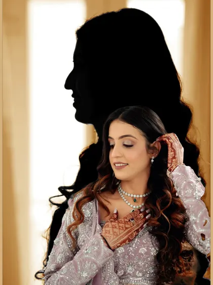 An artistic silhouette portrait of the bride from her engagement shoot. This creative technique adds a unique and memorable image to her collection.