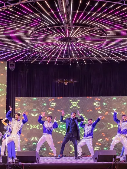 The groom's power-packed performance on a state-of-the-art stage with a massive circular LED ceiling structure.