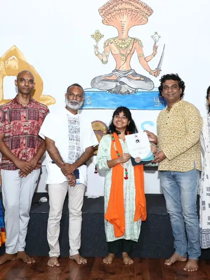 A young graduate proudly receives her certificate, showing that the path of healing is open to all ages.