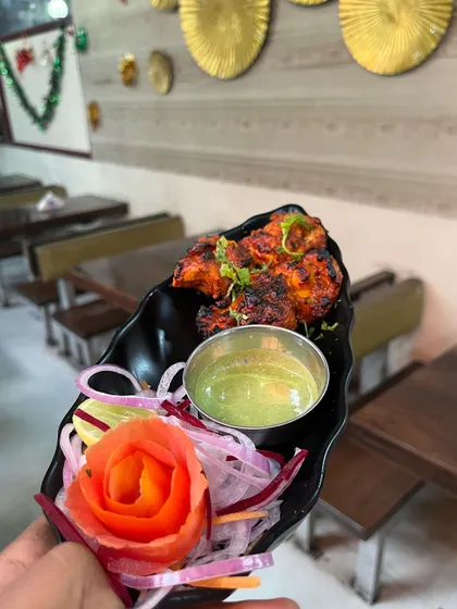 A platter of our perfectly charred Chicken Tikka, served with fresh onions and our signature mint chutney. This is one of our most requested starters for parties and corporate events.