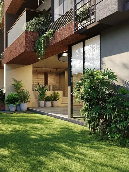 **Sanctum Apartments, Ahmedabad:** A view of the ground-floor amenities and garden. The design ensures that even in a vertical living context, residents have access to green, open spaces for recreation and community interaction.