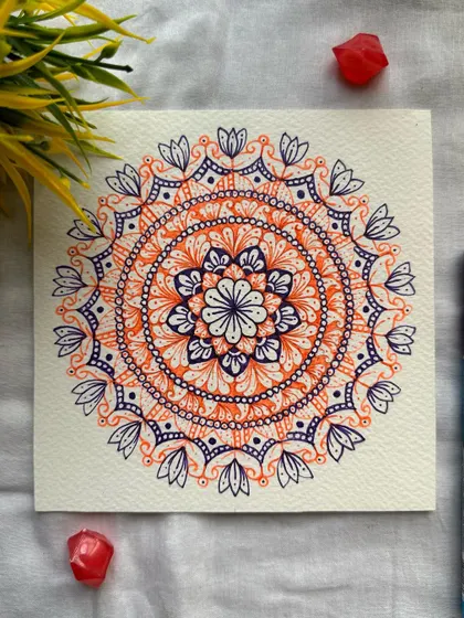 Make it simple, but significant. This two-color mandala in orange and purple is a great example of how a limited palette can be incredibly effective.