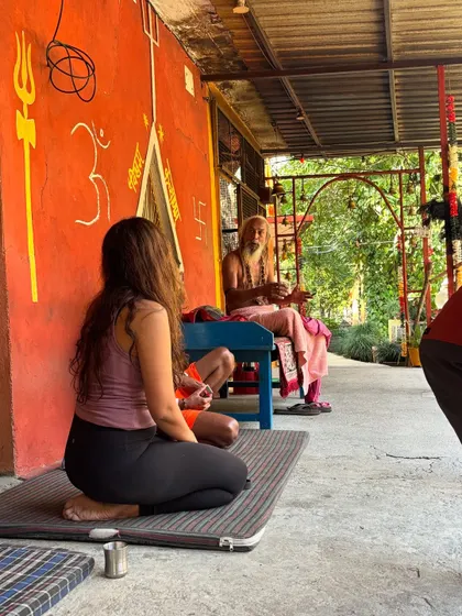 A moment of quiet learning with a sadhu during a retreat hike. These journeys are not just about physical movement but also about absorbing wisdom from unexpected sources and reflecting on our own path.