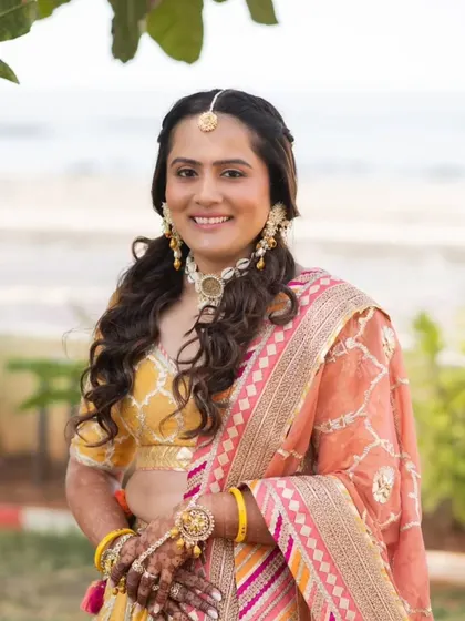 A close-up of her Haldi makeup. The look is minimal and focuses on glowing skin, with a simple maang tikka as the main accessory.