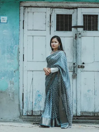 A full-length portrait of a couple against a rustic blue door, showcasing their style and the unique urban location we found for their pre-wedding shoot.