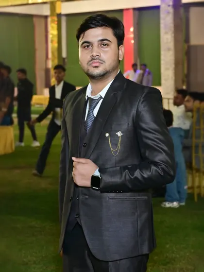 A portrait of a guest looking sharp in a three-piece suit at an outdoor event.