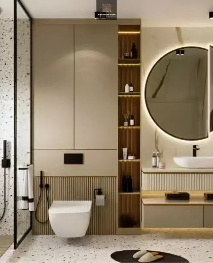 A stylish bathroom with terrazzo-style flooring and walls. The design includes a floating vanity, a round backlit mirror, and open wooden shelving for a modern and airy feel.