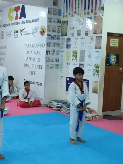 Two blue belt students practicing a synchronized form.