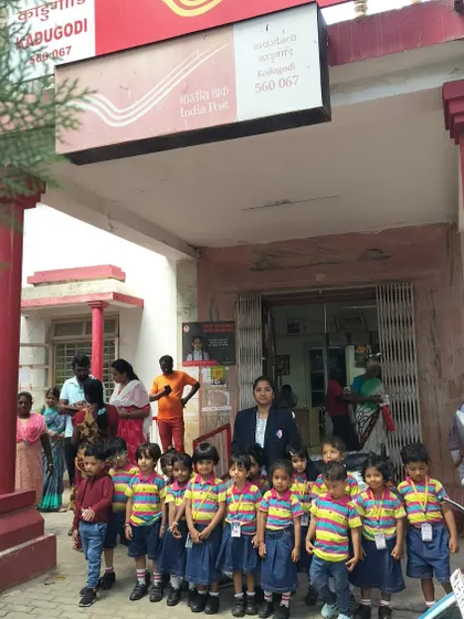 A group photo of our preschoolers and their teacher in front of the Kadugodi post office, marking a successful and educational outing.