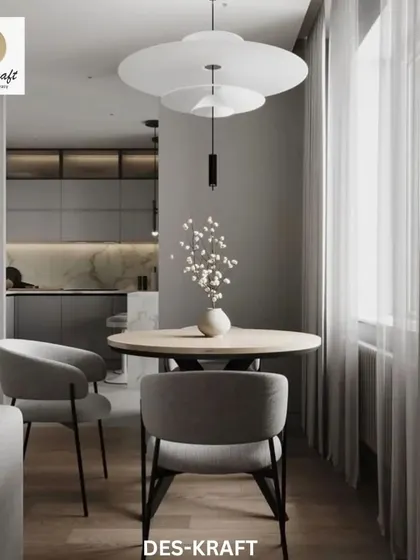 A view from the dining area into the sleek kitchen, showcasing the clean lines and minimalist aesthetic that defines this modern living space.