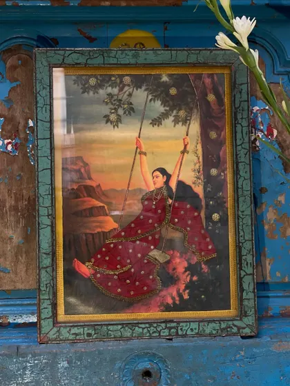 A cloth oleograph depicting a woman on a swing, based on a classic painting. The vintage print is embellished with detailed embroidery, adding a three-dimensional quality to the beautiful scene.