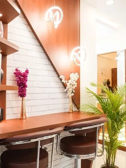 A stylish breakfast bar with a white brick-textured wall and modern pendant lights. This cozy nook is perfect for casual meals and morning coffee.