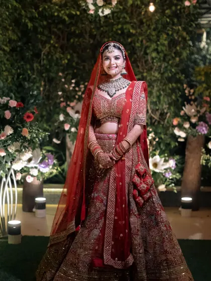 A smiling bride stands confidently in her wedding attire, ready for her big day. A perfect, classic bridal portrait.
