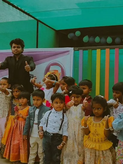 A group of adorable preschoolers giving a thumbs up after my magic show. It's a joy to bring smiles to the faces of these young ones.