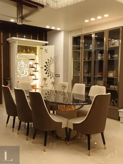 This shot shows the dining area in context with the modern pooja unit and a glass crockery cabinet. The design ensures that all elements in the room are cohesive and complementary.