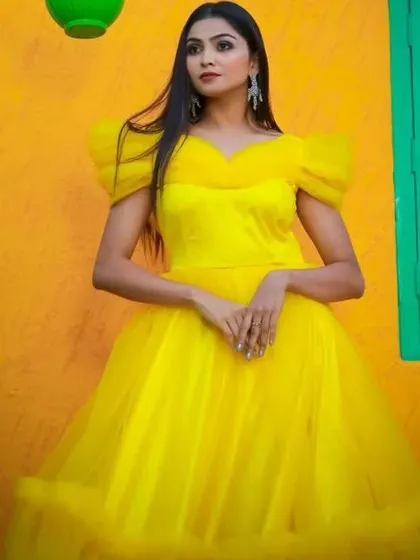 This shot captures the vibrant color and dreamy texture of the yellow gown, perfect for creating fairytale moments.