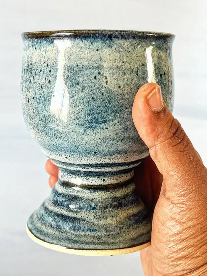 The handmade goblet feels solid and balanced in the hand, perfect for your favorite beverage.
