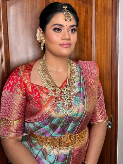 The full traditional attire, complete with a waist belt (vaddanam) and classic updo.