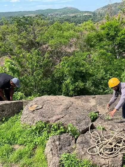 Participants learn to set up secure anchors using natural features like boulders.