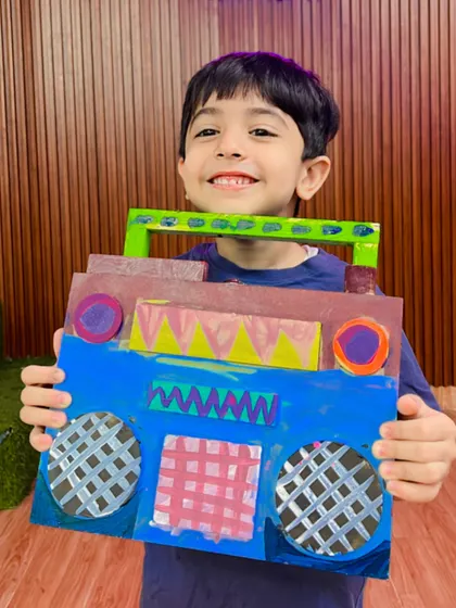 The smile on this student's face shows how proud he is of the retro boombox he created.