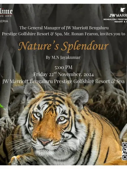 The invitation for 'Nature's Splendour' at JW Marriott, featuring a magnificent tiger photograph by M.N. Jayakumar.