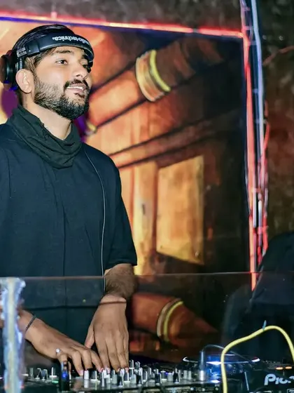In the zone, focused on the mix. This is where I feel most alive, creating a vibe that gets everyone moving. It's my job to lift your spirits with music.