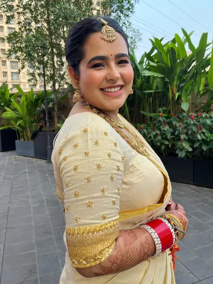 A side profile of the radiant bride. The clean makeup and elegant hairstyle create a look of pure happiness and love.