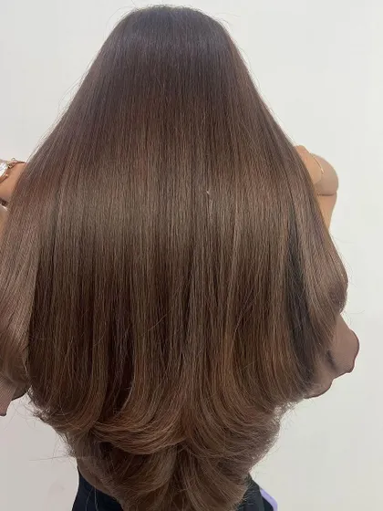A great haircut is everything. Here, we created long, flowing layers to give this beautiful hair shape and volume, making it look fuller and healthier. This kind of cut is perfect for showing off a fresh color.