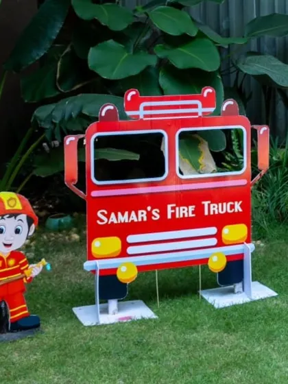 The fire truck photo prop set up in the garden, ready for little heroes.