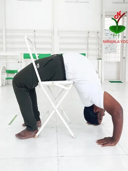 This is a perfect example of how I make challenging poses manageable. By using a chair for support in Chakrasana (Wheel Pose), you can experience the full benefits of this deep backbend without putting excessive strain on your wrists and shoulders.