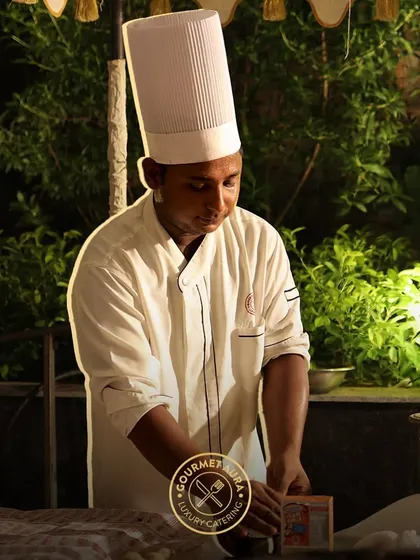 A chef working at night at an outdoor station, focused and dedicated to his craft. Our team works tirelessly to ensure your event is perfect.