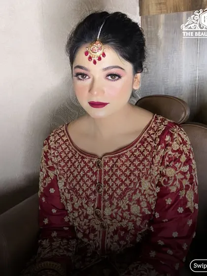 A classic bridal portrait. I created this look with a deep red lip and soft, shimmery eyes to complement her maroon and gold embroidered outfit.
