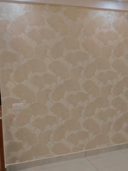 A neutral-toned wallpaper with a subtle, abstract leaf pattern. This design adds texture and a touch of organic style without overwhelming the space.
