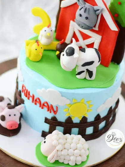 A closer look at the adorable farm animals, including a sheep, cow, and pig, all made from fondant.