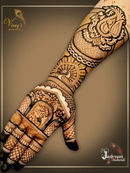 The other hand from the groom's sister's set, featuring an elephant motif on the palm and a large paisley design on the arm.