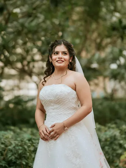 A beautiful outdoor portrait. The makeup is subtle and elegant, perfect for a daytime wedding, ensuring the bride looks and feels her best.