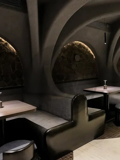The unique, cave-like interiors of 'Call Me Ten' in Delhi, a project where we supplied custom-designed furniture. The organic shapes of the seating booths were crafted to blend seamlessly with the restaurant's avant-garde architecture.