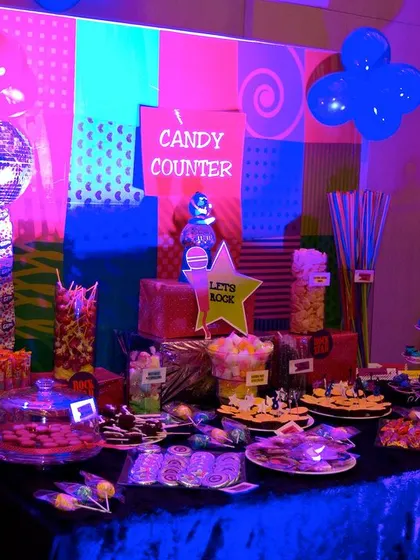 The candy counter at the Rockstar party was a major attraction. Lit with neon lights, it was stocked with a huge variety of sweets and treats for guests to enjoy.