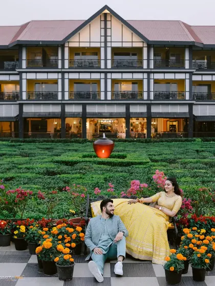 The couple relaxing in the manicured gardens of the Mayfair resort in Siliguri, a moment of calm and connection amidst the wedding festivities.