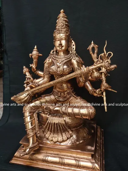 A full view of the Matangi icon, showing her seated on a throne with one leg folded, a classic pose for the goddess of creative arts.
