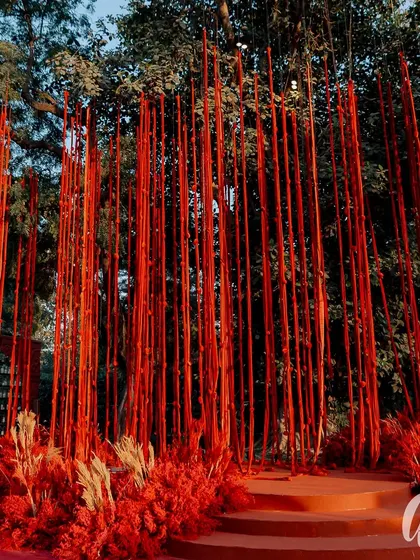 A striking photo backdrop created with hundreds of vertical red-wrapped batons. This installation provided a powerful, textured visual that was both modern and dramatic, perfect for guest photos.