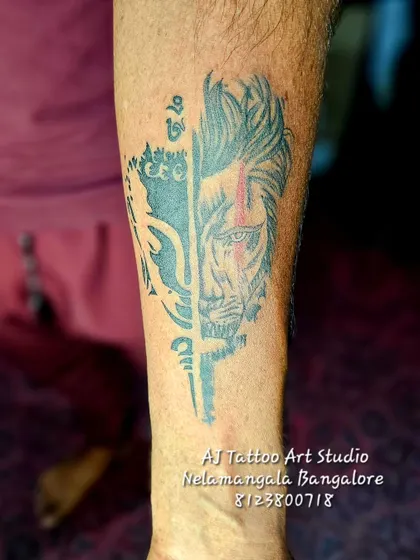 A creative half-face tattoo combining a deity with a lion, symbolizing divine power and courage.