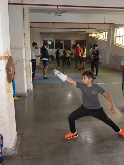 A young fencer practices his attack on a wall target. This solo drill is great for perfecting form and building confidence.