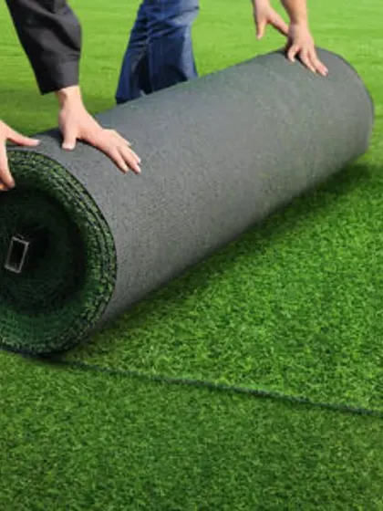 My team unrolling artificial turf during a large-scale installation. I can handle projects of any size, ensuring a seamless and professional finish.