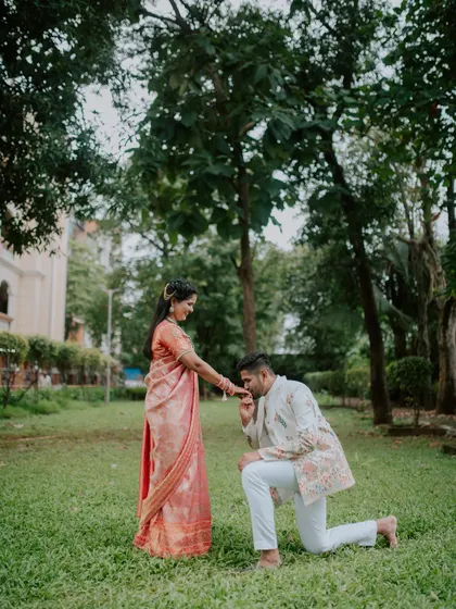 A chivalrous moment as the groom-to-be kisses his fiancée's hand.