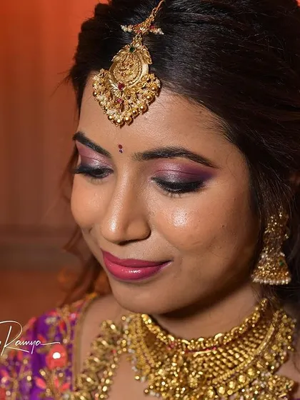 A close-up of Santoshi's reception makeup, featuring a beautiful purple smokey eye that perfectly complements her saree.