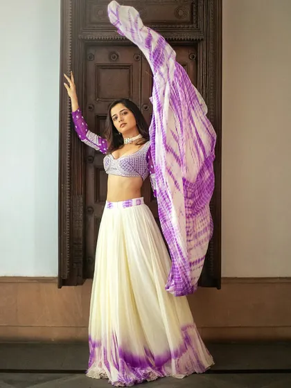 I love working with modern techniques like tie-dye. This off-white and lavender georgette lehenga, designed for Ashika Ranganath, features a beautiful tie-dye pattern and a blouse intricately embroidered with silver katdana and pearls.