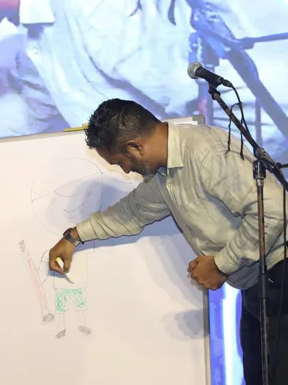 An audience member drawing something on a whiteboard as part of a mentalism act at the KGA. I had to guess what he was drawing, a classic test of mind-reading.
