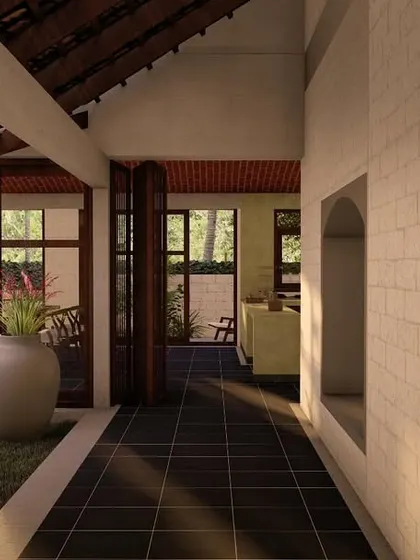 A view through a corridor in the laterite villa, looking into a central courtyard. This architectural feature is key to our designs, bringing light, air, and a piece of the garden into the very heart of the home.